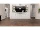 Bright living room with a built-in entertainment center with modern cabinets and decor at 3719 E Sandy Way, Gilbert, AZ 85297