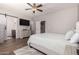 Main bedroom with ensuite bathroom, ceiling fan, dresser, and stylish decor at 3719 E Sandy Way, Gilbert, AZ 85297