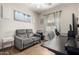 Office with plank flooring including a gray sofa, modern desk, and sail-themed artwork at 3719 E Sandy Way, Gilbert, AZ 85297