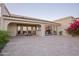 Charming back patio with brick flooring and dual pane glass doors and bougainvillea at 3800 E Lincoln Dr # 31, Phoenix, AZ 85018