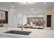 A modern kitchen showcasing a large island, stainless steel appliances, and an open-concept design flowing into the living area at 3800 E Lincoln Dr # 31, Phoenix, AZ 85018
