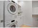 Efficient laundry room featuring stacked washer and dryer, ample storage, and a clean, minimalist design at 3800 E Lincoln Dr # 31, Phoenix, AZ 85018