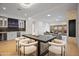 Spacious living area with a sleek dining table, modern lighting, and wet bar area, perfect for entertaining at 3800 E Lincoln Dr # 31, Phoenix, AZ 85018