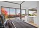 Spacious main bedroom with a four-poster bed, balcony access, and an ensuite bathroom, showcasing bright, natural light at 3800 E Lincoln Dr # 31, Phoenix, AZ 85018