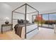 Inviting main bedroom featuring a four-poster bed, plush bedding, and seamless access to a private balcony at 3800 E Lincoln Dr # 31, Phoenix, AZ 85018