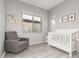 A serene Bedroom featuring a crib, rocking chair, and soft gray walls for a calming atmosphere at 3884 S Wilson Dr, Chandler, AZ 85286