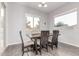 Bright dining room features wood floors, a rustic table, and natural light through dual windows at 3884 S Wilson Dr, Chandler, AZ 85286