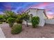 A bright home exterior with a manicured landscape, stone-covered ground and charming architectural details at 3884 S Wilson Dr, Chandler, AZ 85286