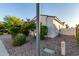 A bright home exterior with a manicured landscape, stone-covered ground and charming architectural details at 3884 S Wilson Dr, Chandler, AZ 85286