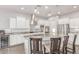 Bright kitchen with large island, stainless steel appliances, and white cabinets offers modern convenience at 3884 S Wilson Dr, Chandler, AZ 85286