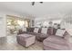 Bright living room featuring hardwood floors, a purple sofa, and access to other rooms in the house at 3884 S Wilson Dr, Chandler, AZ 85286