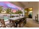 Covered patio with wood furniture offers an outdoor dining space overlooking the pool and backyard at 3884 S Wilson Dr, Chandler, AZ 85286