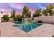 Backyard pool with rock waterfall feature, spa and lush desert landscaping at 3884 S Wilson Dr, Chandler, AZ 85286