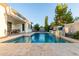 Beautiful backyard pool with waterfall and covered patio, perfect for outdoor entertaining and relaxation at 3884 S Wilson Dr, Chandler, AZ 85286
