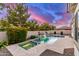 Backyard pool with spa, rock waterfall feature, and lush desert landscaping create a serene oasis at 3884 S Wilson Dr, Chandler, AZ 85286