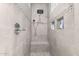 A tiled stand-up shower featuring a bench, recessed shelving, and decorative tile trim at 3884 S Wilson Dr, Chandler, AZ 85286