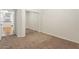 Carpeted bedroom features a sliding mirror closet and an entrance to the kitchen at 4212 E Jasper Dr, Gilbert, AZ 85296