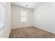 Bright bedroom featuring neutral carpet, white walls, and a window allowing natural light at 4212 E Jasper Dr, Gilbert, AZ 85296