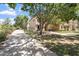 A tree partially obscures the charming home with well-kept landscaping at 4212 E Jasper Dr, Gilbert, AZ 85296
