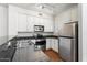 Functional kitchen features granite countertops, stainless steel appliances, and wooden flooring at 4212 E Jasper Dr, Gilbert, AZ 85296
