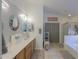 Elegant bathroom with dual sinks, wooden cabinets, and a glass door shower stall at 45138 W Norris Rd, Maricopa, AZ 85139