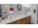 Bright bathroom features double sinks, wooden cabinets, and decorative mirrors at 45138 W Norris Rd, Maricopa, AZ 85139