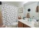 Bathroom featuring patterned shower curtain, vanity with sink, and decorative elements at 45138 W Norris Rd, Maricopa, AZ 85139