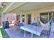 A view of the covered patio featuring a dining table and a hammock at 45138 W Norris Rd, Maricopa, AZ 85139