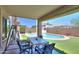 Relax on the covered patio overlooking the sparkling pool and manicured backyard at 45138 W Norris Rd, Maricopa, AZ 85139