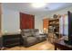 Cozy den with a sofa, bookshelf, and a decorative rug, creating a comfortable retreat at 45138 W Norris Rd, Maricopa, AZ 85139