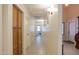 Hallway featuring tile floors, neutral walls, and multiple entryways and storage cabinets at 45138 W Norris Rd, Maricopa, AZ 85139