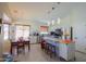 Bright kitchen featuring stainless steel appliances, an island with bar seating, and adjacent dining area at 45138 W Norris Rd, Maricopa, AZ 85139