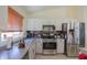 Kitchen showcasing stainless steel appliances, countertops, and a sink under a bright window at 45138 W Norris Rd, Maricopa, AZ 85139