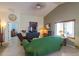 Bright living room featuring a plush green couch and lots of natural light at 45138 W Norris Rd, Maricopa, AZ 85139