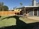 Spacious backyard with covered patio, wooden fence, and well-kept lawn at 4608 W Gail Dr, Chandler, AZ 85226
