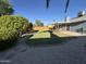 Well-maintained backyard featuring a lush lawn, mature trees, and secure wooden fence at 4608 W Gail Dr, Chandler, AZ 85226