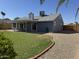 Backyard exterior featuring a covered patio and lush green lawn at 4608 W Gail Dr, Chandler, AZ 85226