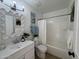 Bright bathroom featuring a white vanity, decorative mirror, and tub with shower at 4608 W Gail Dr, Chandler, AZ 85226