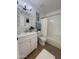Bright bathroom featuring a white vanity, decorative mirror, and tub with shower at 4608 W Gail Dr, Chandler, AZ 85226