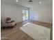 Spacious bedroom with new floors, white walls, and a sliding glass door to the backyard at 4608 W Gail Dr, Chandler, AZ 85226