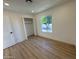 Bright bedroom with wood-look floors, closet, and view of tree at 4608 W Gail Dr, Chandler, AZ 85226