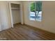 Bright bedroom features wood-look floors, closet, and view of tree at 4608 W Gail Dr, Chandler, AZ 85226