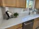 Bright kitchen features quartz counters, wood cabinets and stainless dishwasher at 4608 W Gail Dr, Chandler, AZ 85226