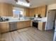 Well-lit kitchen featuring wooden cabinets, stainless steel appliances, and white countertops at 4608 W Gail Dr, Chandler, AZ 85226