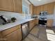 Bright kitchen boasts wood cabinets, quartz countertops and stainless appliances at 4608 W Gail Dr, Chandler, AZ 85226