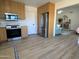 Bright kitchen features stainless steel appliances, wood cabinets, and a view into the adjacent living area at 4608 W Gail Dr, Chandler, AZ 85226