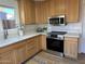 Kitchen boasts wood cabinets, quartz countertops, stainless appliances and a large sink at 4608 W Gail Dr, Chandler, AZ 85226