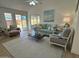 Bright and airy living room with a comfortable sofa, chair and view of the fenced backyard at 4608 W Gail Dr, Chandler, AZ 85226