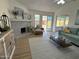 Bright and airy living room featuring a modern fireplace, comfortable seating and a view to the backyard at 4608 W Gail Dr, Chandler, AZ 85226
