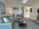 Living room featuring a blue sofa, accent chair, and beach-themed decorations at 4608 W Gail Dr, Chandler, AZ 85226